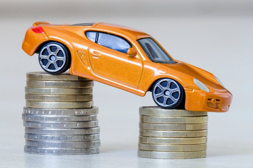 Car balancing on a pile of coins