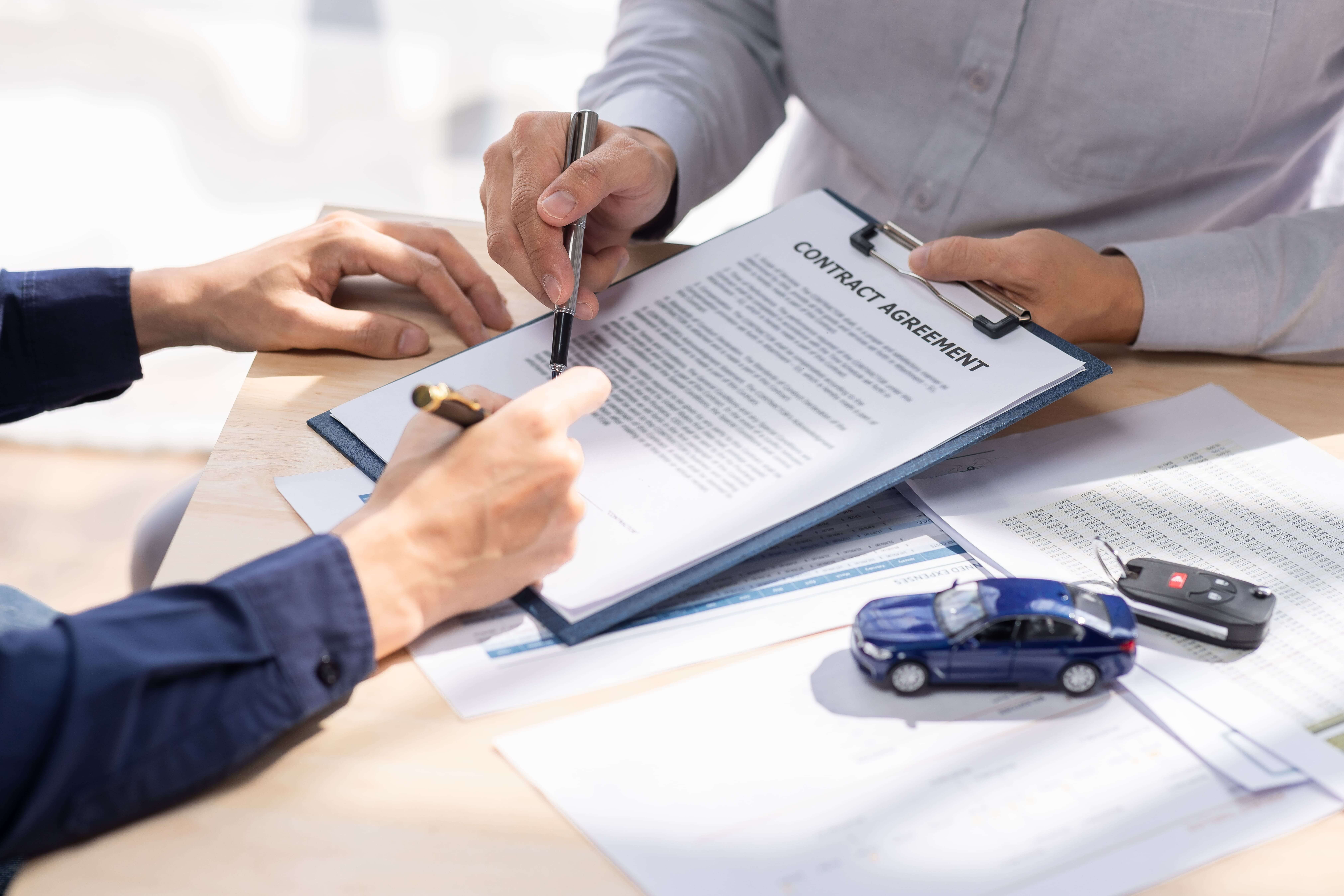 Customer signing car finance document
